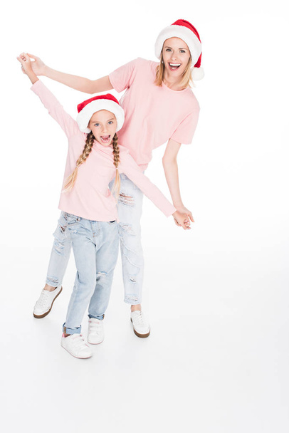 mother and daughter holding hands on christmas - Фото, изображение