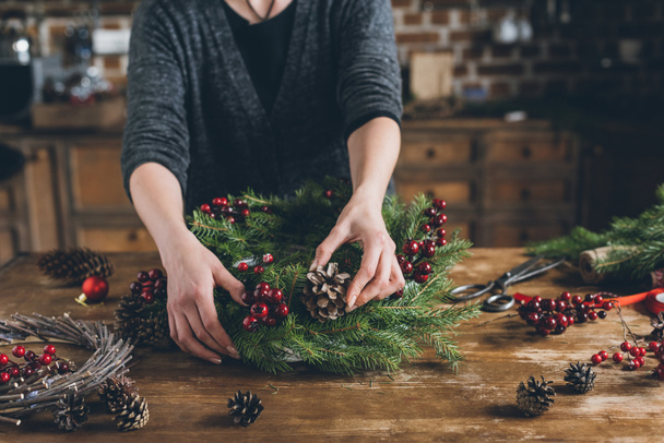 florist making Christmas fir wreath  - Photo, Image