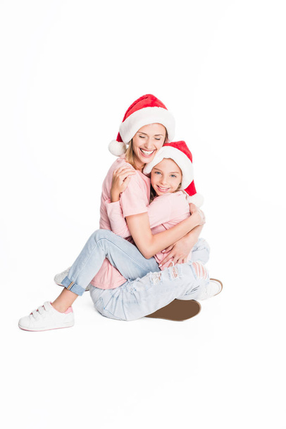 mother and daughter hugging on christmas - Фото, изображение