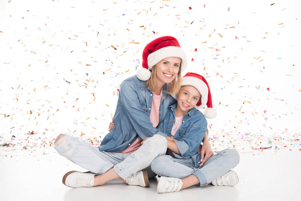 mother and daughter with confetti on christmas - Фото, зображення