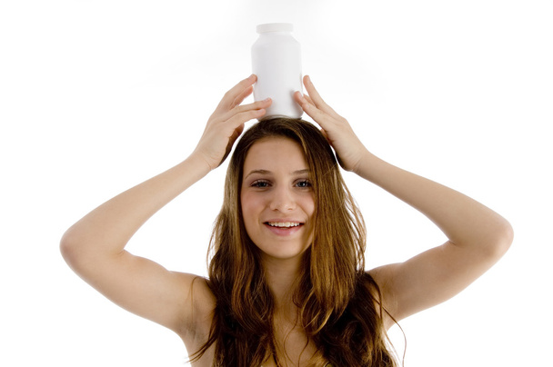 Woman balancing plastic bottle on head - Valokuva, kuva