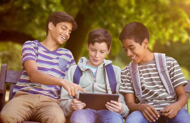 Boy with friends using digital tablet  - 写真・画像