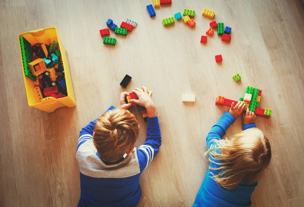 little boy and girl play with plastic blocks - Photo, Image