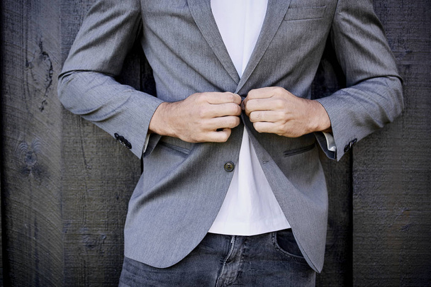 Guy in jeans buttoning suit jacket - Fotografie, Obrázek