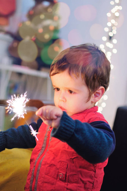 Little boy holding a sparkle stick - Photo, Image