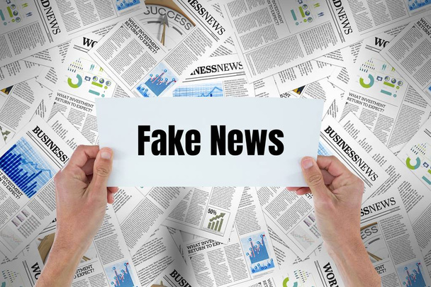 Hands holding card with Fake news  - Фото, зображення