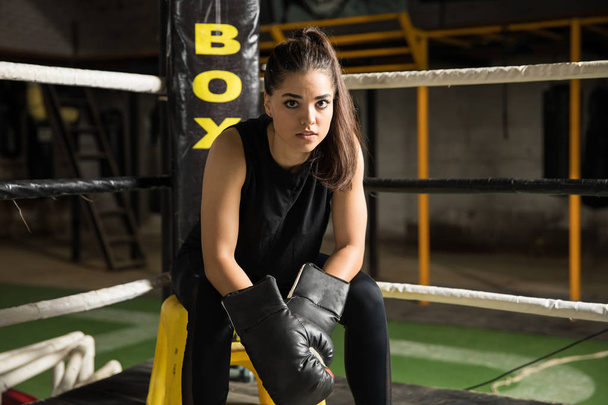 Female boxer sitting in a corner - Photo, Image