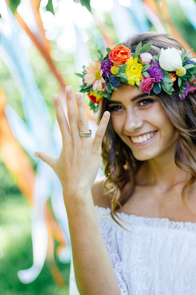 Happy bride after wedding ceremony showing fingers with wedding ring and smiling. - Photo, Image