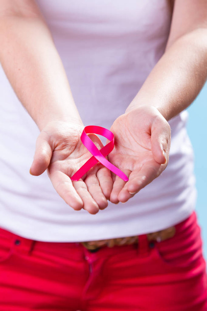Woman with breast cancer awareness ribbon on hands - Foto, immagini