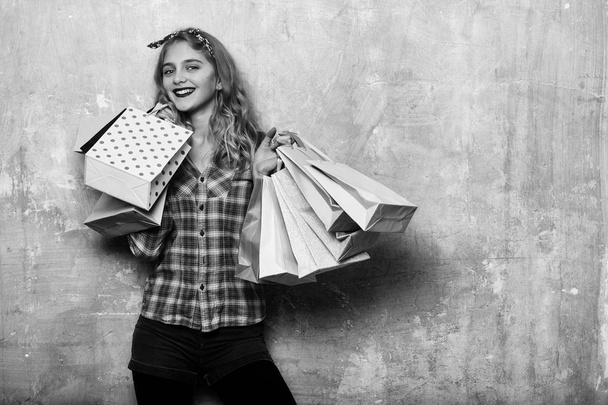 Happy pretty girl with colorful shopping bags in hands - Fotó, kép