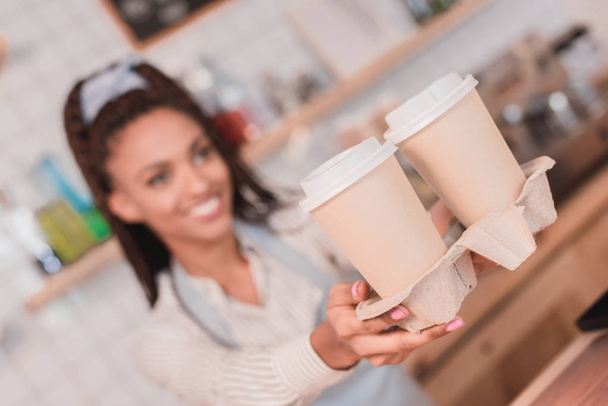 barista handing out holder with cups - Photo, Image