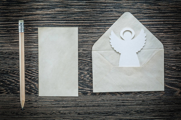 Vintage envelope blank paper angel pencil on black board - Zdjęcie, obraz