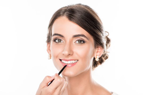 makeup artist applying lipstick on model - Photo, Image