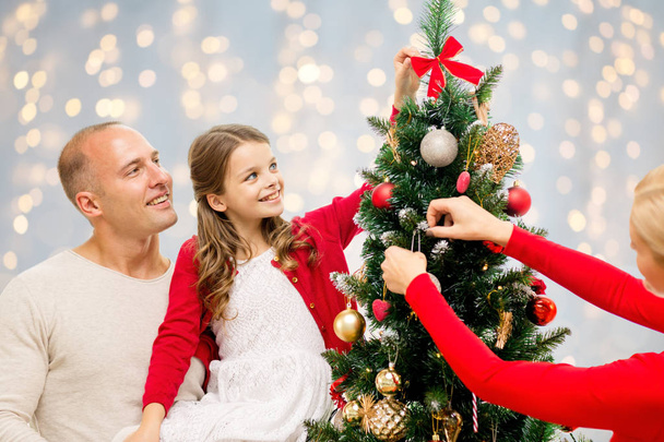 mother, father and daughter at christmas tree - 写真・画像