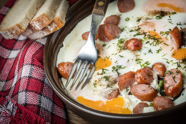 Tasty cooked egg with chopped sausages. - Φωτογραφία, εικόνα