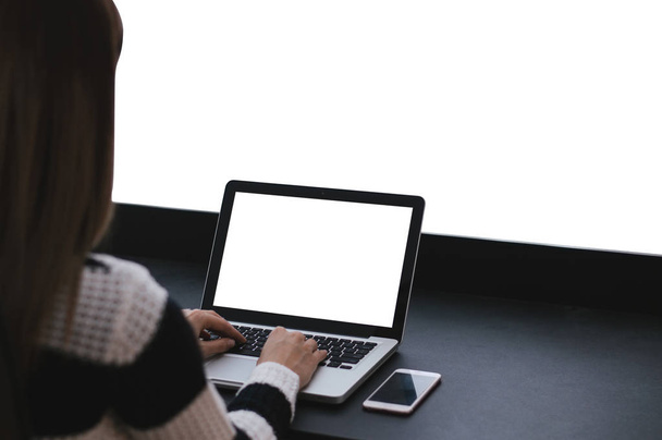 Girl working on laptop with white screen - Φωτογραφία, εικόνα