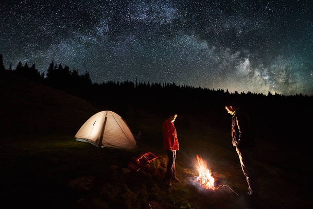 Couple of tourists at night camping - Photo, Image