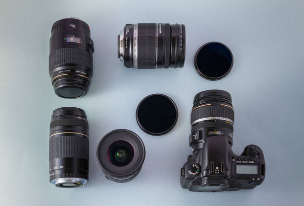 Camera, lenses and filters on blue background, top view - Foto, Imagem