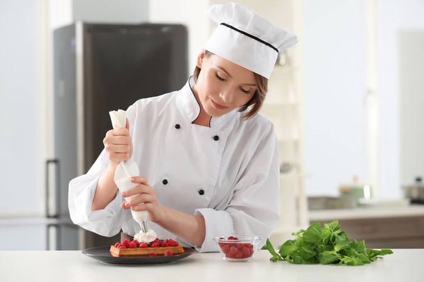 Female chef decorating dessert   - Фото, изображение