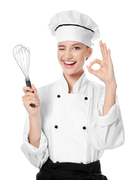 Young female chef with whisk on white background - Foto, afbeelding