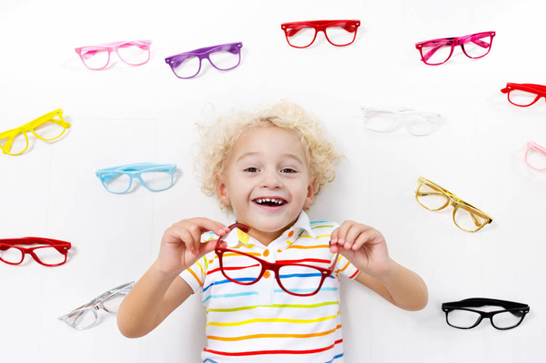 Child at eye sight test. Kid at optitian. Eyewear for kids. - Photo, Image
