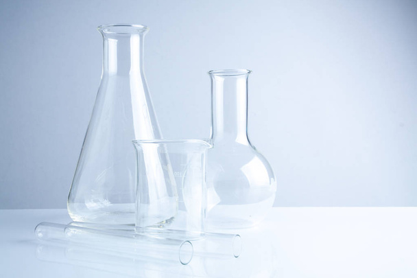 Laboratory glassware on table, Symbolic of science research. - Φωτογραφία, εικόνα