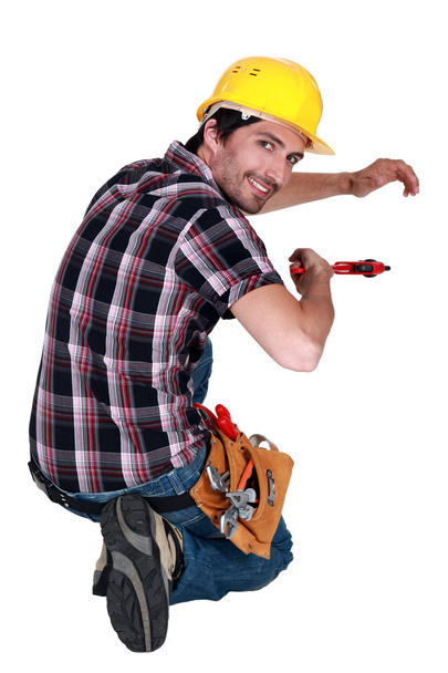 Tradesman using a pipe wrench - Fotoğraf, Görsel