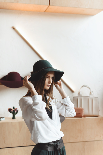 woman choosing hat in boutique - Foto, imagen