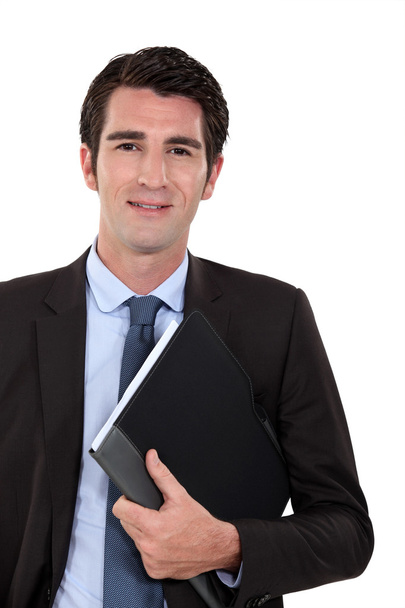 Confident businessman holding folder underarm - Fotoğraf, Görsel