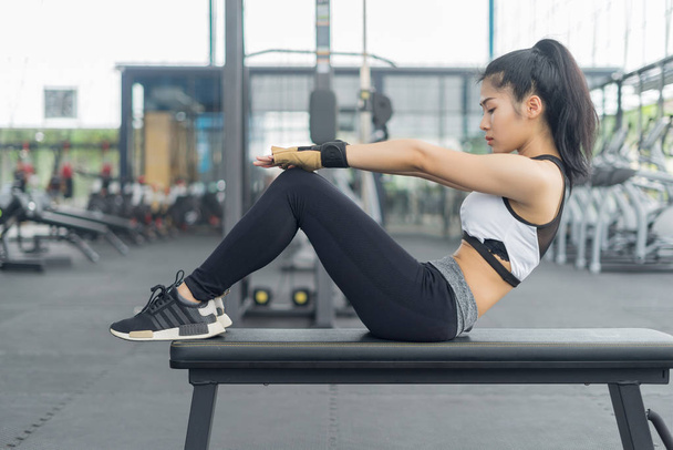 Fitness woman showing sit up exercises in gym, fitness concept, sport concept - Fotoğraf, Görsel