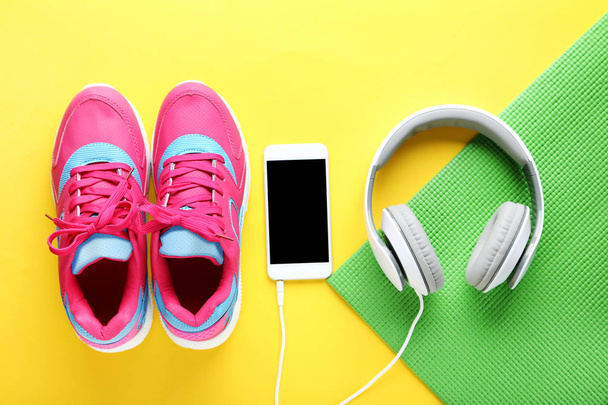 Sport shoes with smartphone and headphones  - Foto, Bild