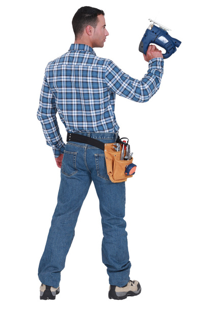 A handyman with a jigsaw. - Фото, зображення