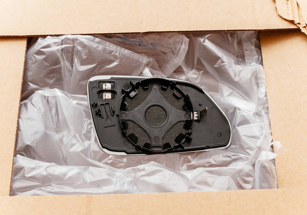 Unboxing of new wing mirror fender mirror from cardboard box  - Photo, Image