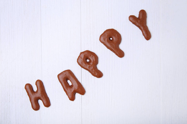 Word Happy written by chocolate cookies   - Zdjęcie, obraz