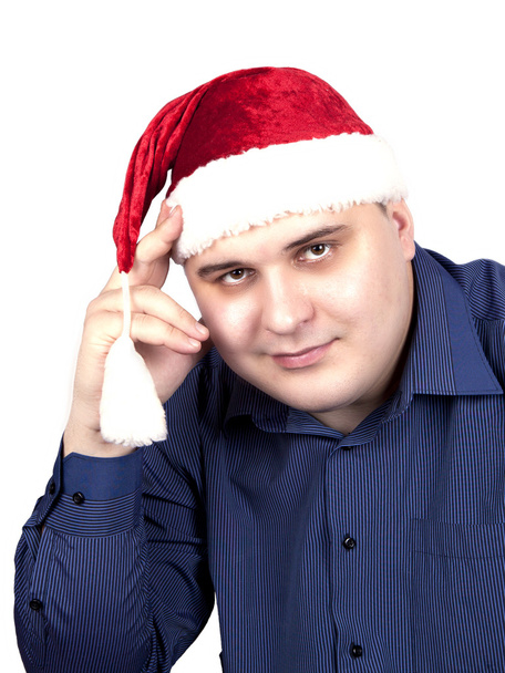 Young man in a blue shirt and in a cap of Santa Claus - Foto, Bild