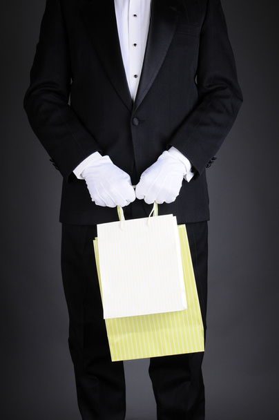 Man in Tuxedo with Gift Bags - Фото, изображение