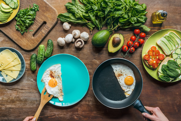 woman serving fried eggs for breakfast - Photo, Image