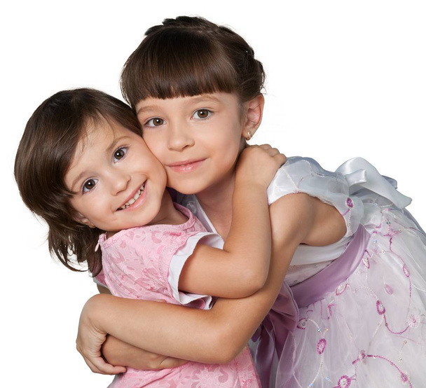 Portrait of beautiful girls hugging and posing while looking at camera, isolated on white - Fotoğraf, Görsel
