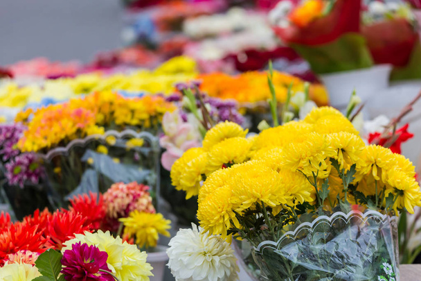 Different bouquets of colorful flowers in the city market - Fotó, kép