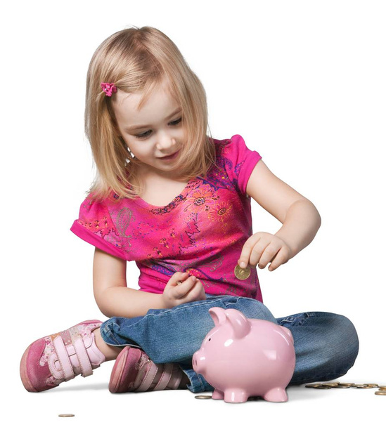 Cute little girl in pink dress with piggy bank isolated on white background - Фото, изображение