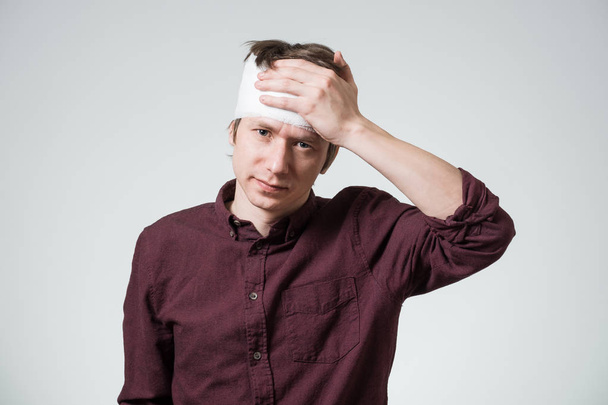 Man with bandage on his head - Фото, изображение