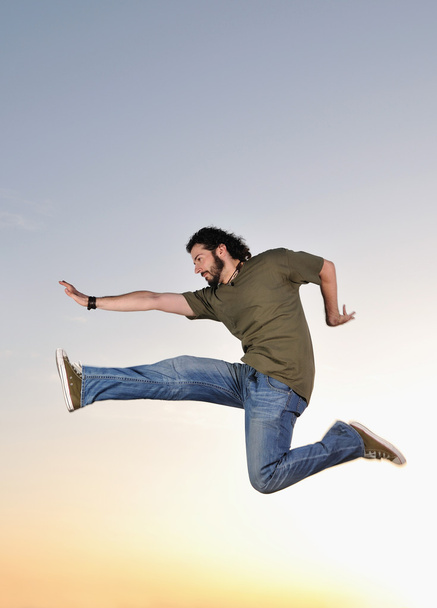 Man jumping outdoor sunset - Фото, зображення