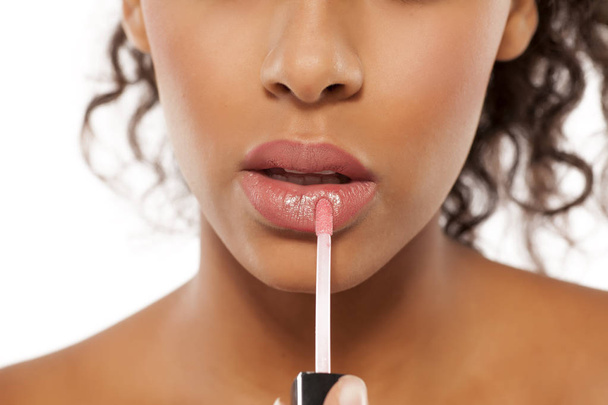 woman applying lipstick  - Фото, изображение