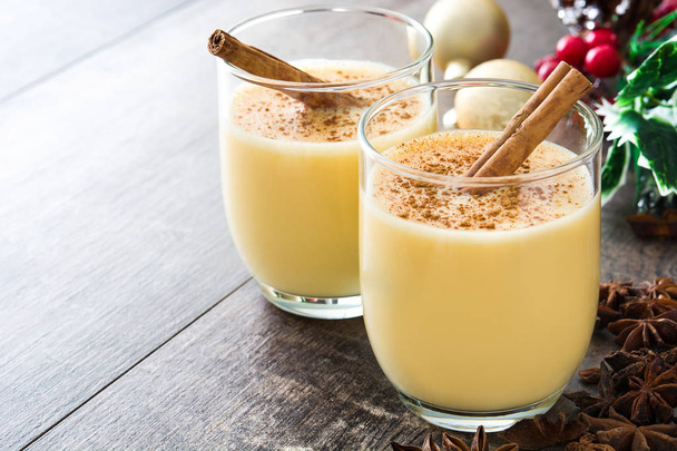 Homemade eggnog with cinnamon on wooden table. Typical Christmas dessert. - Foto, Imagem