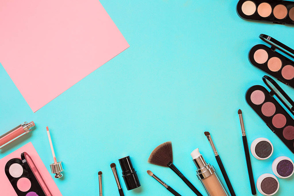 Various cosmetics and brushes on blue background - Φωτογραφία, εικόνα