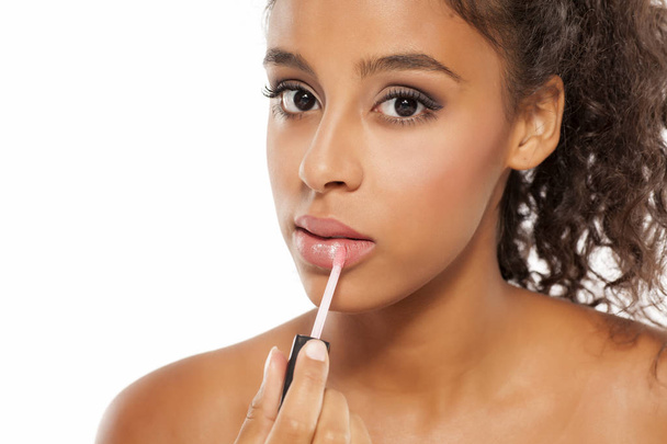 woman applying lip gloss  - Фото, изображение