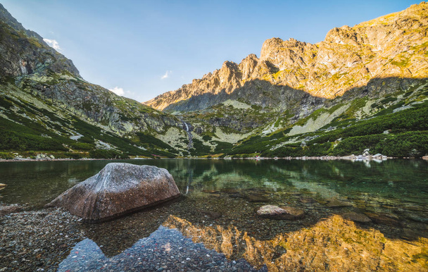 Mountain Lake with Rock in Foreground at Sunset - Photo, Image