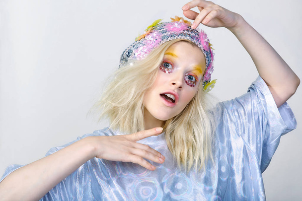 Chica joven con maquillaje colorido en sombrero espumoso
 - Foto, imagen
