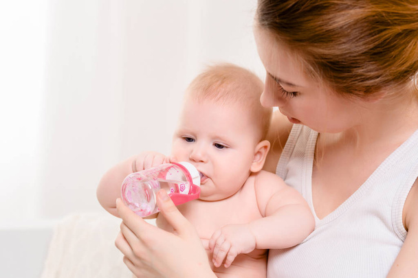 Feeding Baby. Baby eating milk from the bottle. - Valokuva, kuva