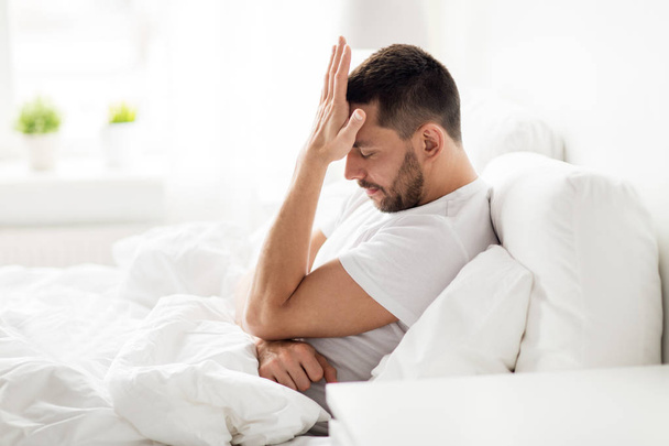 stressed man in bed at home - Foto, Imagem